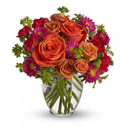 Light orange roses, orange spray roses, and matsumoto asters, hot pink miniature carnations lovely g